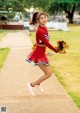 A woman in a cheerleading uniform jumping in the air.