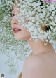 A woman with a flower crown on her head.