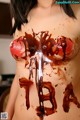 A woman covered in chocolate with the word PBA written on it.